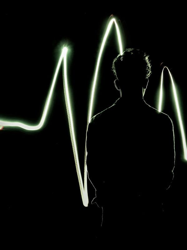 Abstract silhouette of a human body with glowing energy lines.